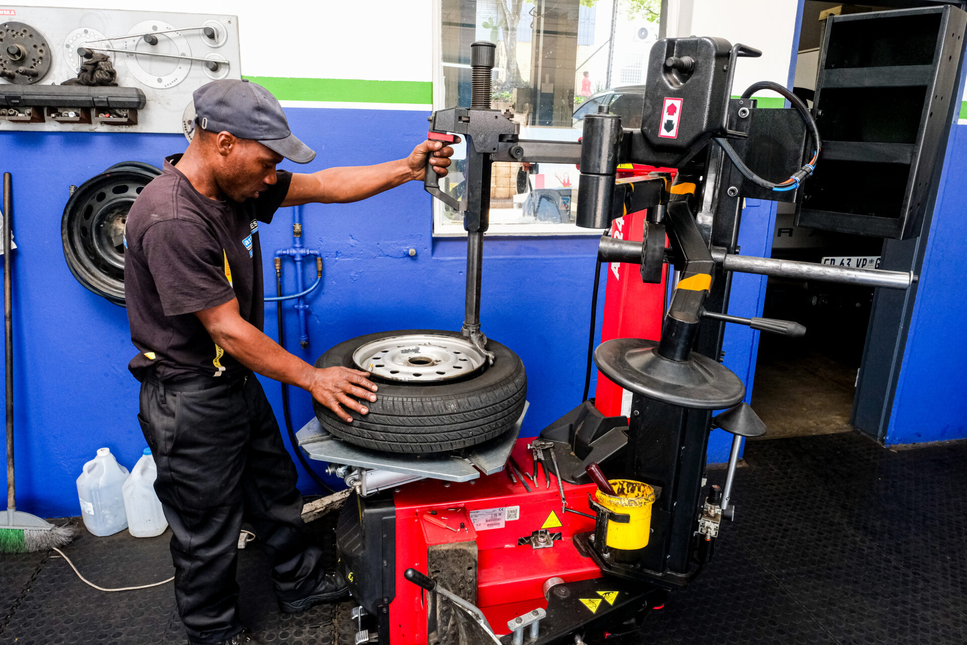 An Astro Tyres technician working on a tyre.