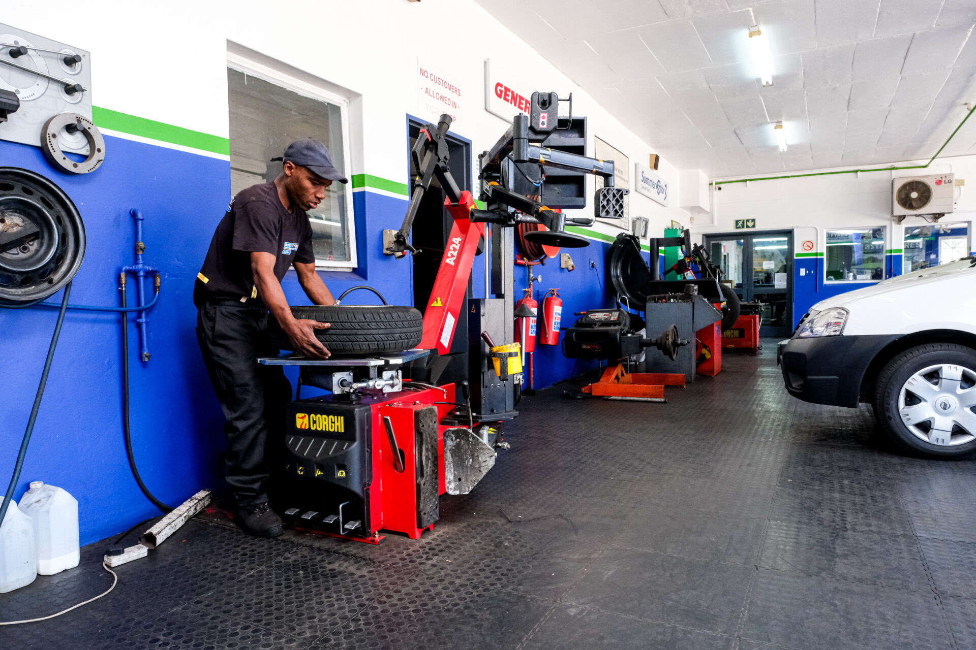An Astro Tyres technician working on a tyre.