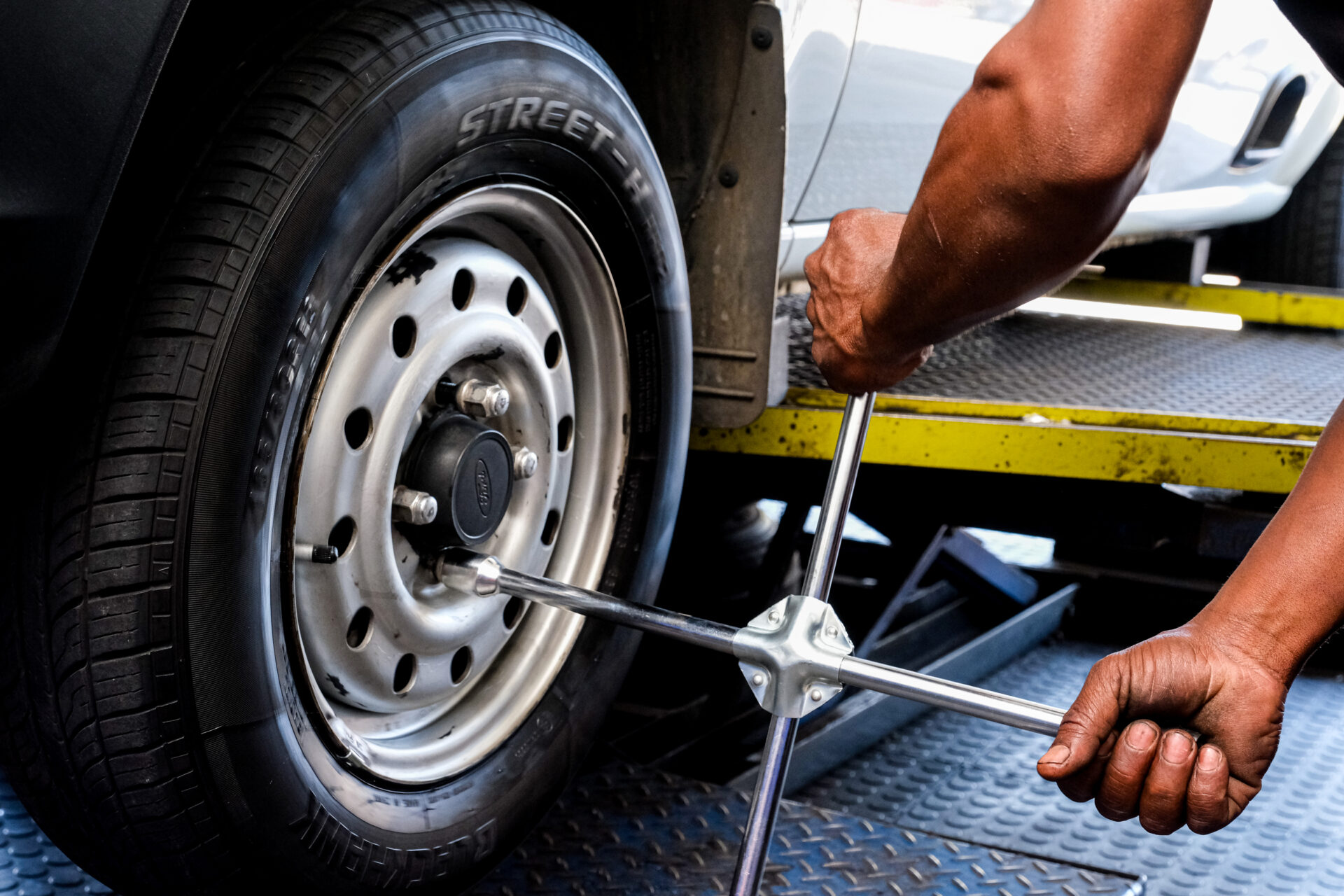 An Astro Tyres technician working on a tyre.