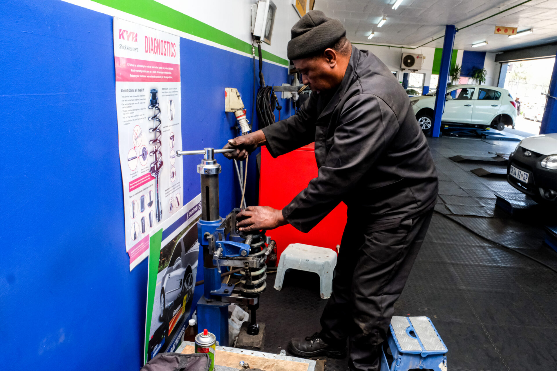An Astro Tyres technician working on a suspension shock.