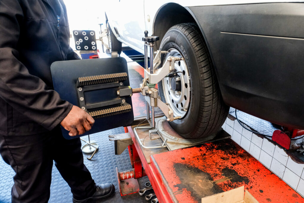 An Astro Tyres technician working on a wheel allignment