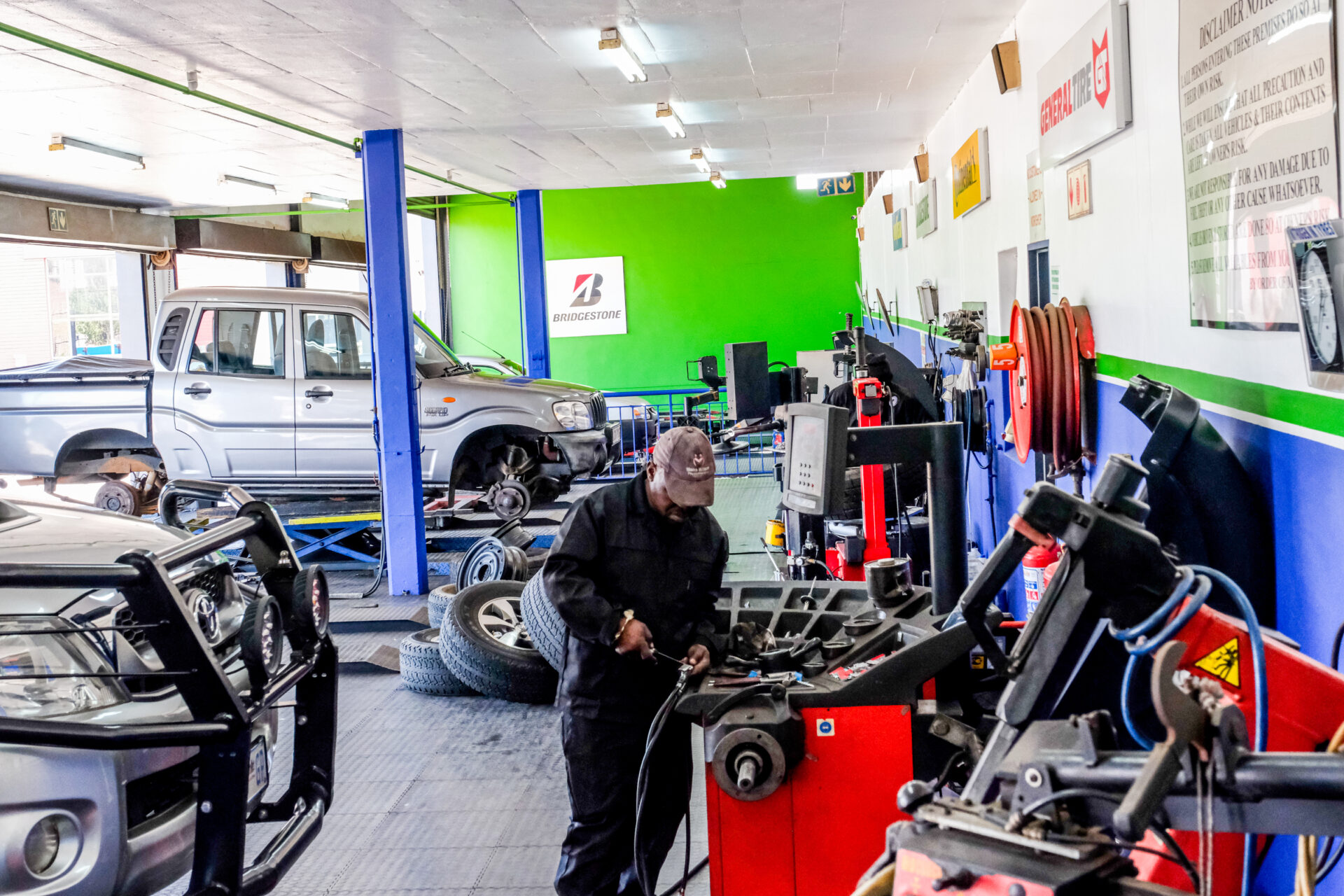 An Astro Tyres technician working on a suspension shock.